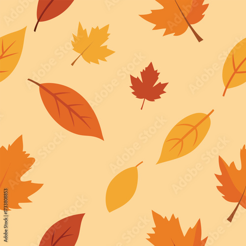 Seamless pattern of autumn leaves in warm colors on a light background