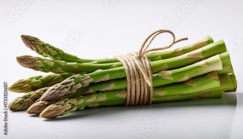 Bundle Of Fresh Green Asparagus Tied With Twine On A Clean White Background