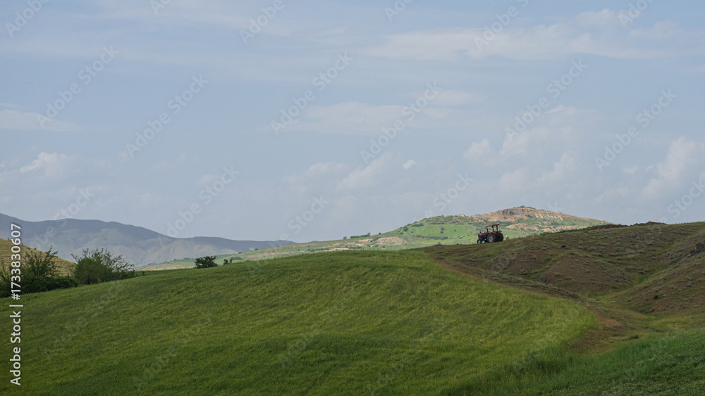 Obraz premium Eco-friendly tractor on lush green hills in rural Turkey