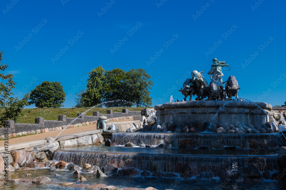 Obraz premium Copenhagen, Denmark 07-20-2025 The Gefion fountain is a large-scale group of bronze oxen pulling a plow and being driven by the Norse goddess Gefjon and located on the harbour front in Copenhagen