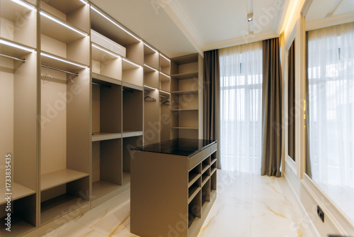 Contemporary Walkin Closet Featuring a Beautiful and Elegant Design Enhanced by Natural Light