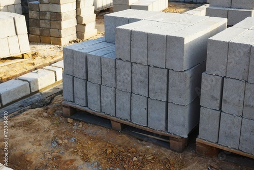 Cement blocks stacked on a pallet at a construction site. Ready for masonry and construction work.
