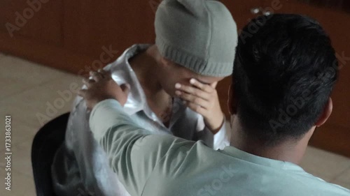 South Asian cancer patient, young woman cancer patient crying after chemotherapy treatment, receiving family or friend support and encouragement  