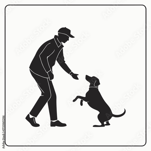 Man in cap training dog to stand on hind legs dog training