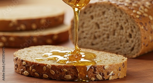 Golden honey drizzling down onto nutritious multigrain bread makes for a tasty and wholesome breakfast or snack, perfect for a healthy lifestyle