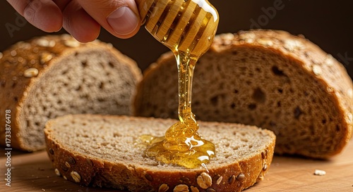 Golden honey drizzling luxuriously onto fresh whole wheat bread slice, promising delicious wholesome breakfast or snack indulgence