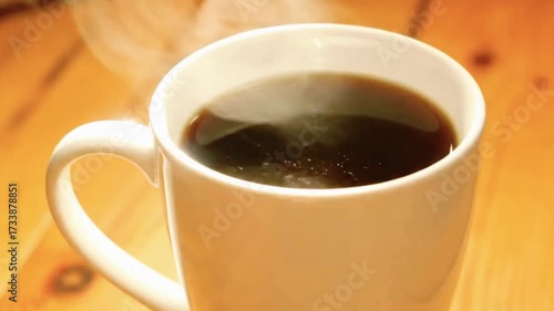 Steaming hot coffee in a cozy mug, perfect for a warm morning start or a relaxing break during the day.