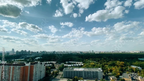 Clouds are running across the sky over a big city. You can see how the horizon touches the ground. Taken with a wide-angle lens