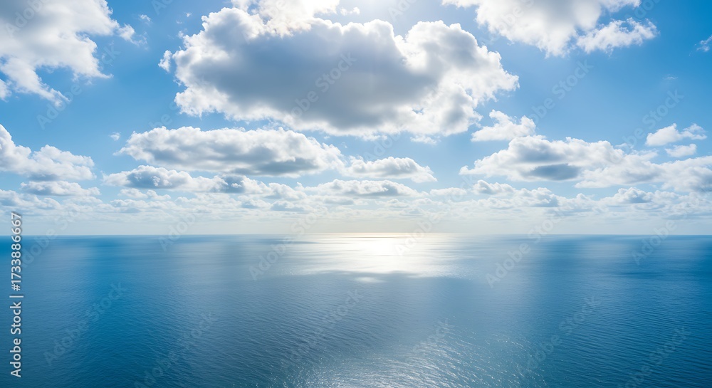 Obraz premium Aerial view of ocean horizon under a bright blue sky and white clouds