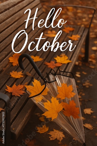 Hello October text. Transparent umbrella filled with colorful maple leaves rests against a wooden bench covered in autumn foliage. 