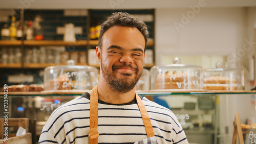 Portrait Of Man With Down Syndrome Working In Food Shop