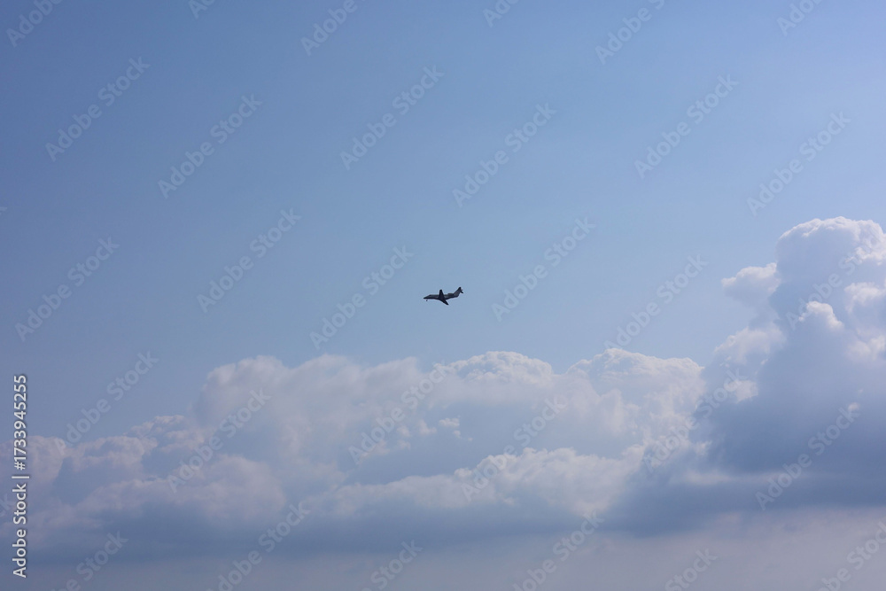 Fototapeta premium Airplane flying in beautiful blue sky, bottom view