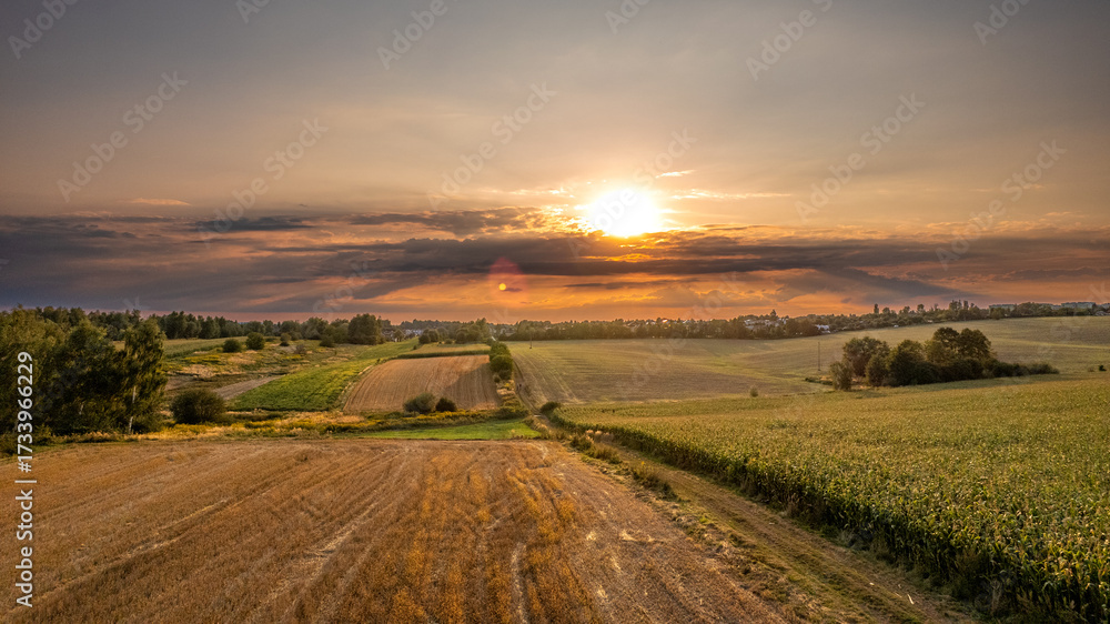 Fototapeta premium Sunset Over Rural Fields and Cloudscape, Poland – Aerial Countryside Panorama