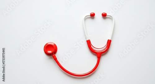 Vibrant red toy stethoscope neatly arranged on a pristine white surface featuring crisp even illumination a symbol of childhood play