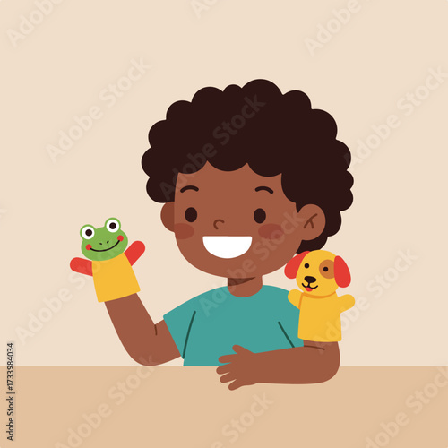 Young boy wearing a teal shirt, happily playing with frog and dog hand puppets