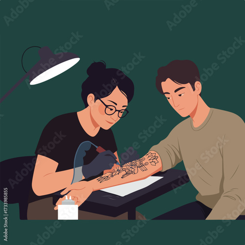 Artist applies floral tattoo to man's arm under bright lamp