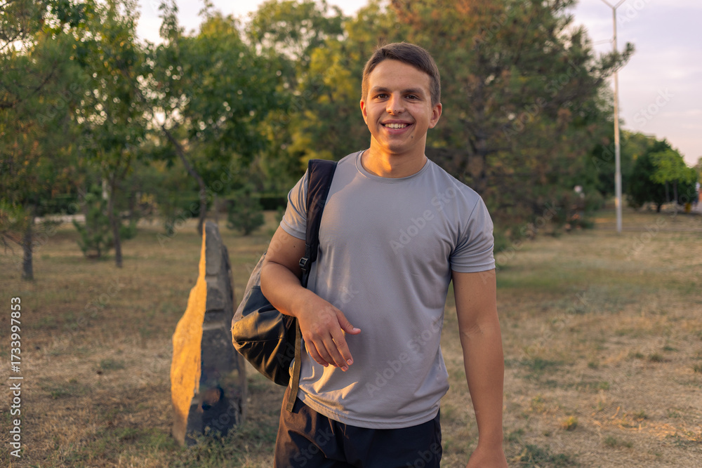 Fototapeta premium Young athletic man walking in the park on a sunny day.