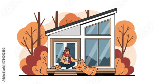 Cozy Autumn Retreat: Woman Enjoying a Hot Drink on the Porch of a Modern Cabin Surrounded by Fall