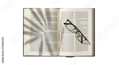 An open book with reading glasses on the right page and the shadow of a palm leaf on the left, viewed from above on a white background.
