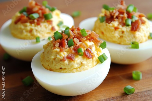 Three deviled eggs wooden surface are round have with Bacon
