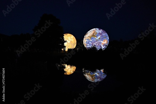 Huge illuminated models of planets and earth in the evening at the observatory. Brno Czech Republic Festival of planets.