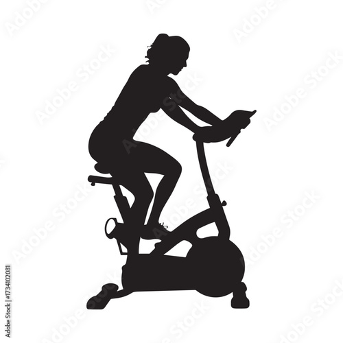 Silhouette of a woman exercising on a stationary bicycle indoors