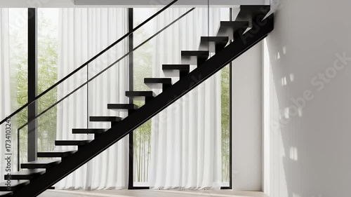 A modern minimalist black floating staircase inside a bright, sunlit room with large windows and sheer white curtains.