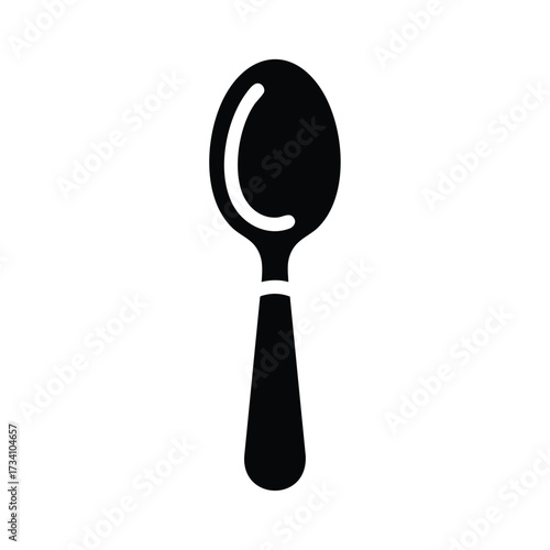 Close-up of a stainless steel spoon with a reflective and ergonomic handle on a plain
