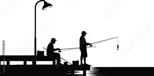 Silhouette of two people fishing on dock with streetlamp, gear, and fish in peaceful outdoor waterfront scene.