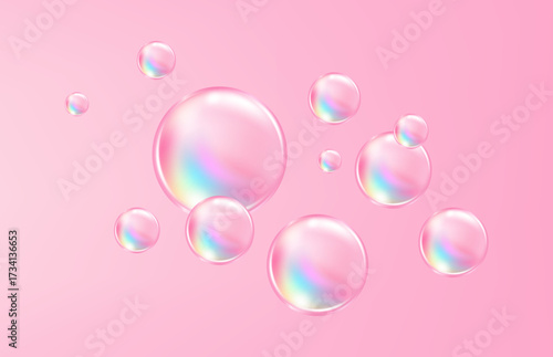 Delicate flying pink bubbles with rainbow reflections on a soft pink background.
