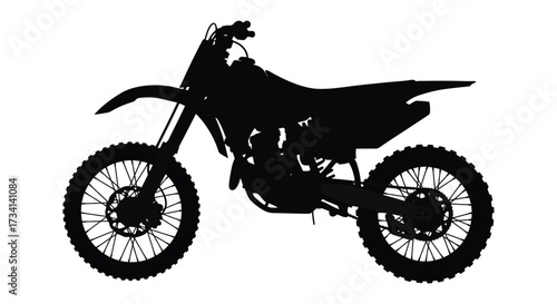 A black dirt bike stands prominently displayed as a striking silhouette