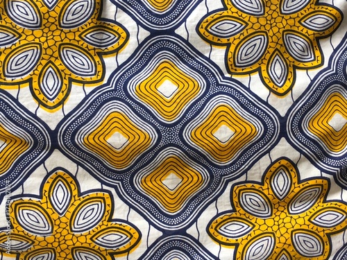 Traditional African wax print fabric floral geometric repeating diamond motifs yellow, white, blue print textile