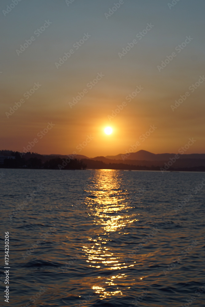 Obraz premium A stunning orange and pink sunset over the Greek Ionian Ocean in the Mediterranean Sea