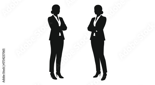 Two confident businesswomen standing with arms crossed a powerful silhouette