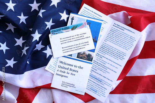 Fotografie Permanent resident green card in envelope and guide for new immigrants lies on U
