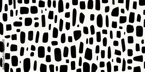 Black irregular blob shapes on an off-white background
