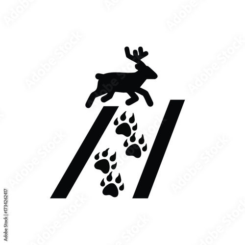 Silhouette of a deer leaping over a trail of animal footprints on a