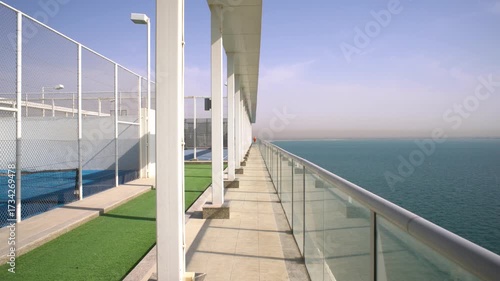 A stunning view of the embankment along the modern embankment with a transparent sky and an ocean background in a coastal place.