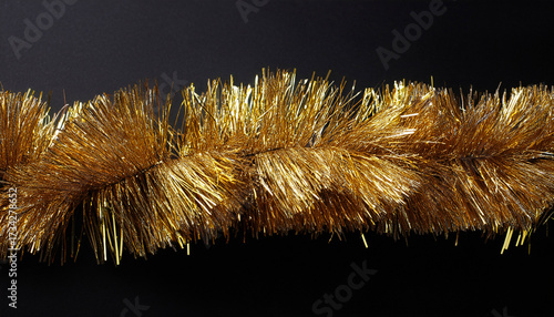 Stripe Of Gold Tinsel On Black Background