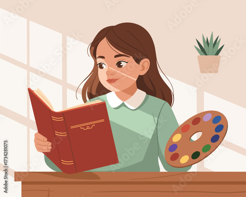 Young girl engrossed in reading a book with an art palette nearby