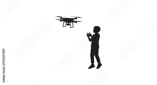 Boy operating a drone with remote control a striking black silhouette