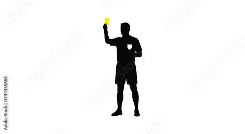 Referee holding up a yellow card in a striking silhouette