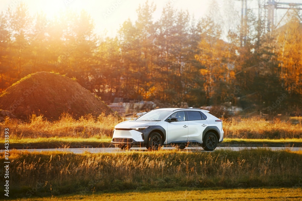 Fototapeta premium Elegant SUV on open road in sunlight