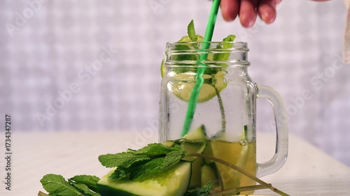 Making healthy cucumber mint and lime refreshing detox drink 
