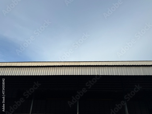 Factory building on the roof against the blue sky