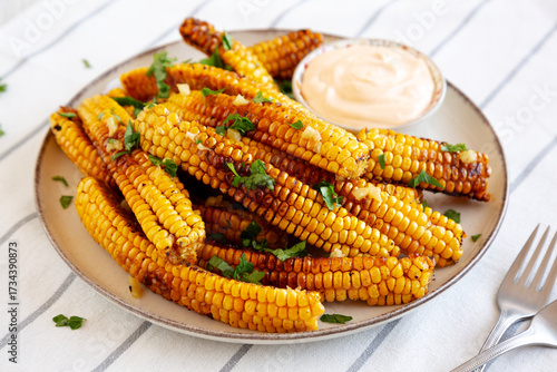 Homemade Spicy Corn Ribs with Mayo on a Plate, side view.