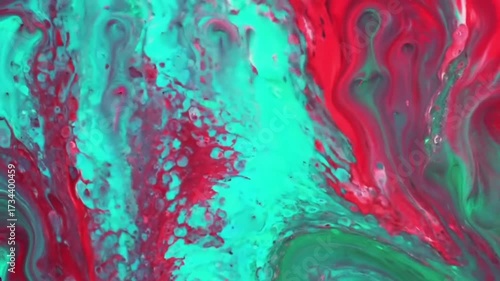 Vibrant abstract fluid painting in motion with red and green colors