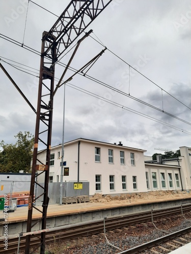 a train stop next to the tracks on a cloudy day
