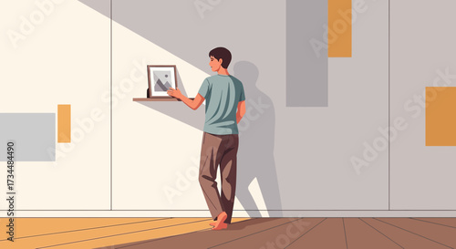 Man adjusting picture frame in minimalist room bathed in natural light creating serene atmosphere