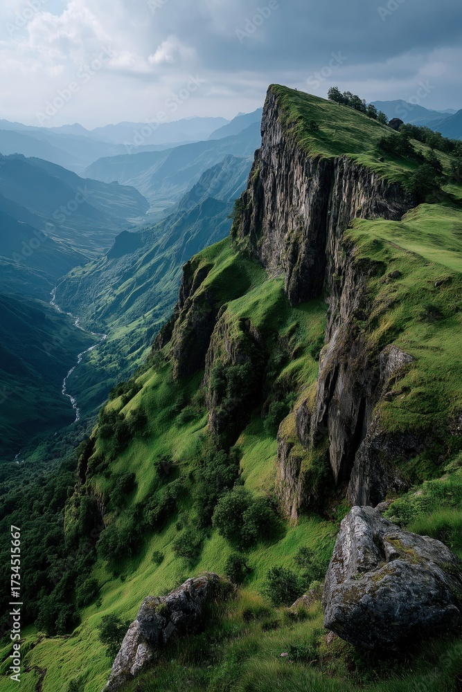 Fototapeta premium Green mountain cliff overlooking dramatic valley landscape